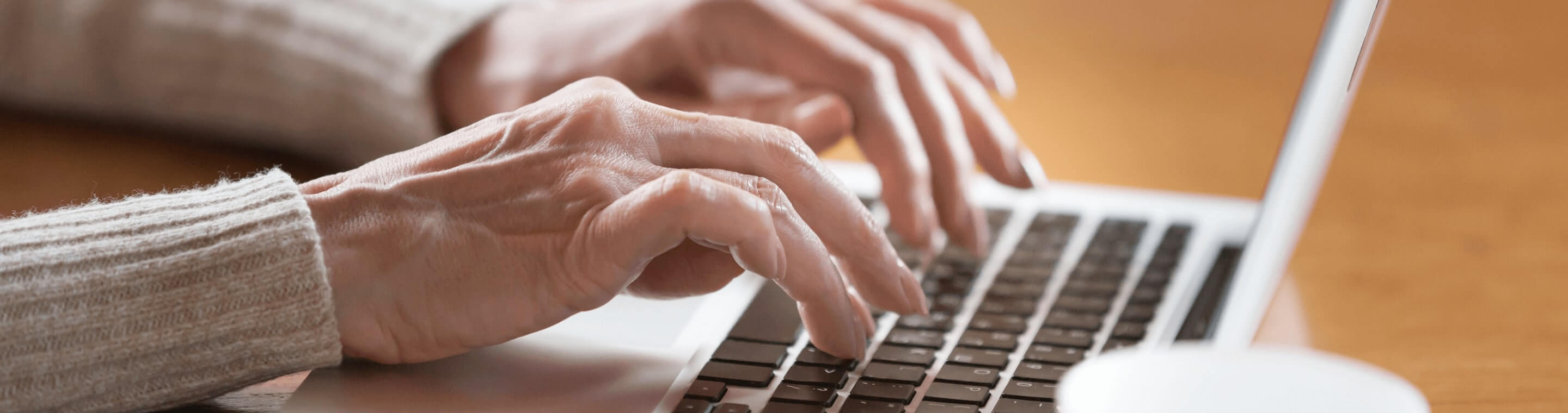 Close up image of female hands typing on laptop