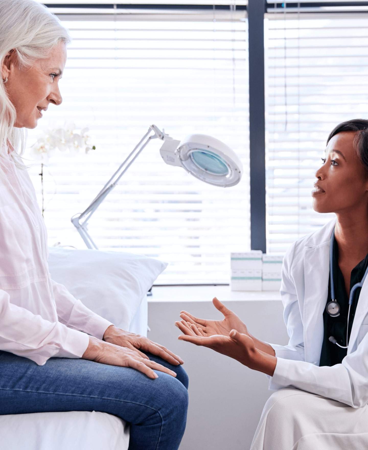 Image of a healthcare professional and a man looking at a tablet