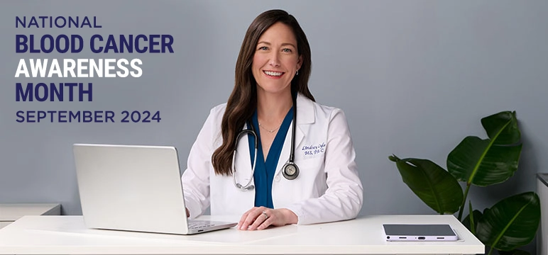 Female MPN expert sitting in front of a laptop linking to the Blood Cancer Awareness blog