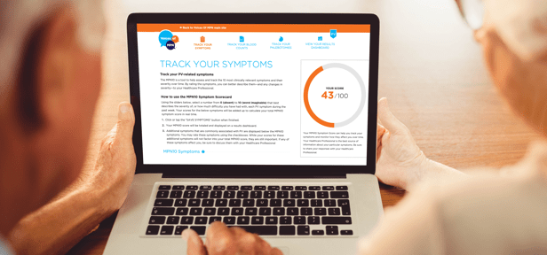 Image of an elderly couple sitting in front of a laptop that has the PV Tracker Tool on the screen