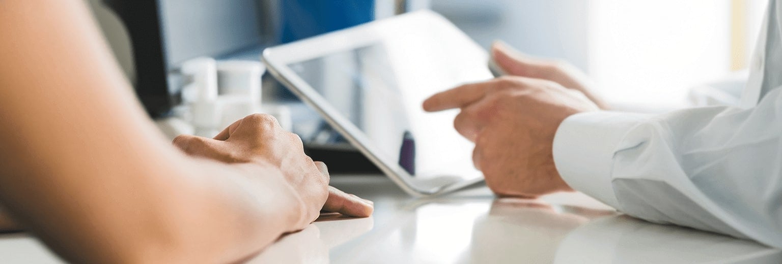 Close-up image of hands holding a tablet