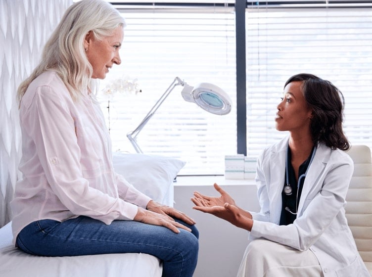 Image of a healthcare professional and a man looking at a tablet