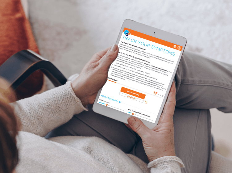 Image of a woman sitting on an exam table listening to a healthcare professional