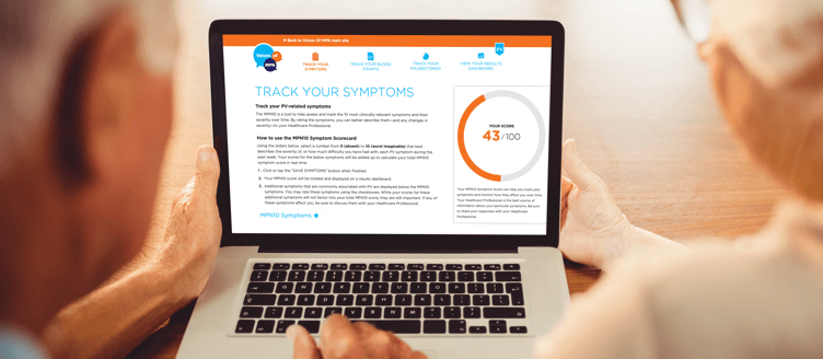 Image of an elderly couple sitting in front of a laptop that has the PV Tracker Tool on the screen