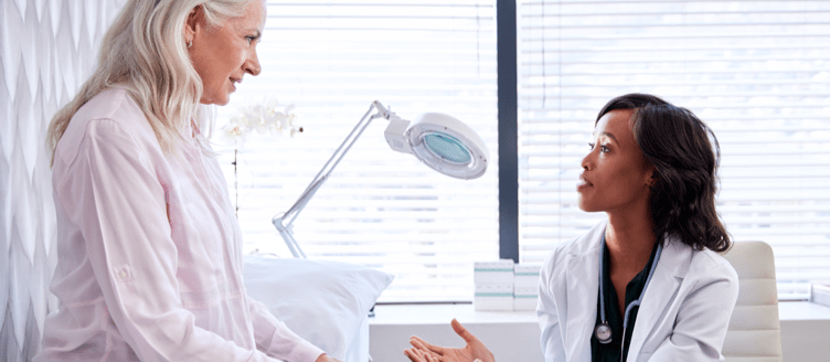 Image of a healthcare professional and a man looking at a tablet