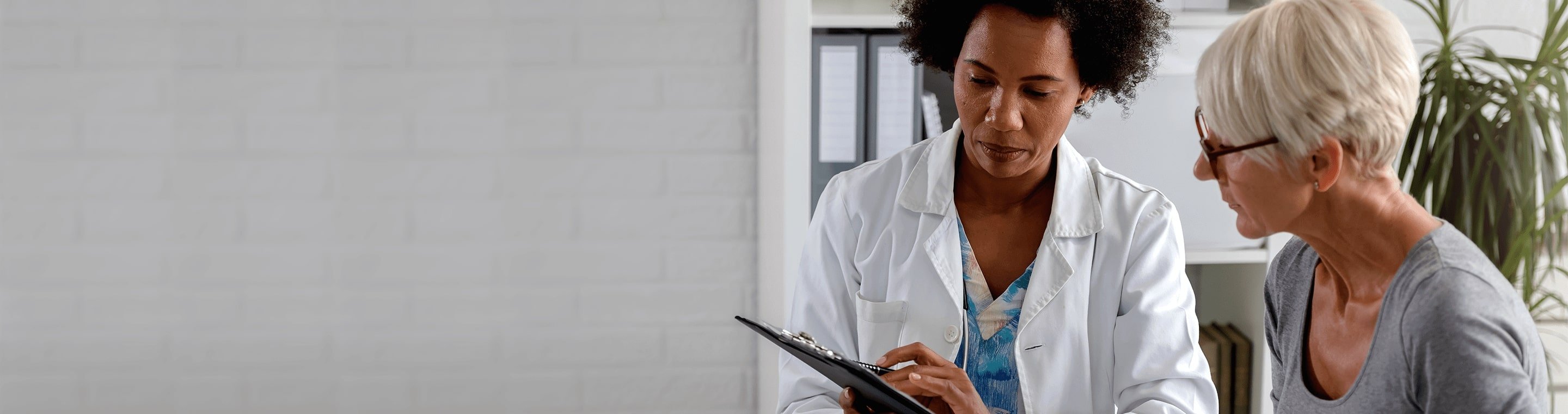 Female doctor talking to a female patient