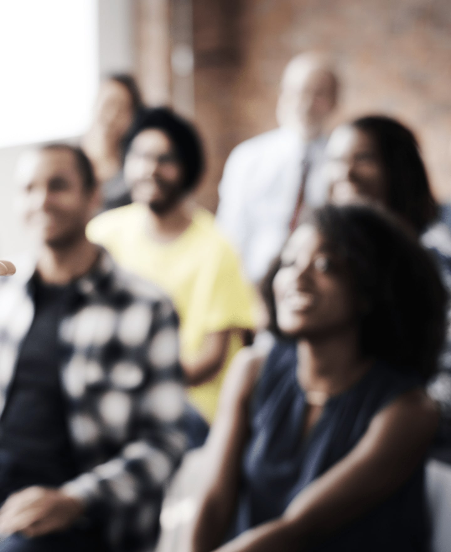 Image of a group of people listening to a speaker