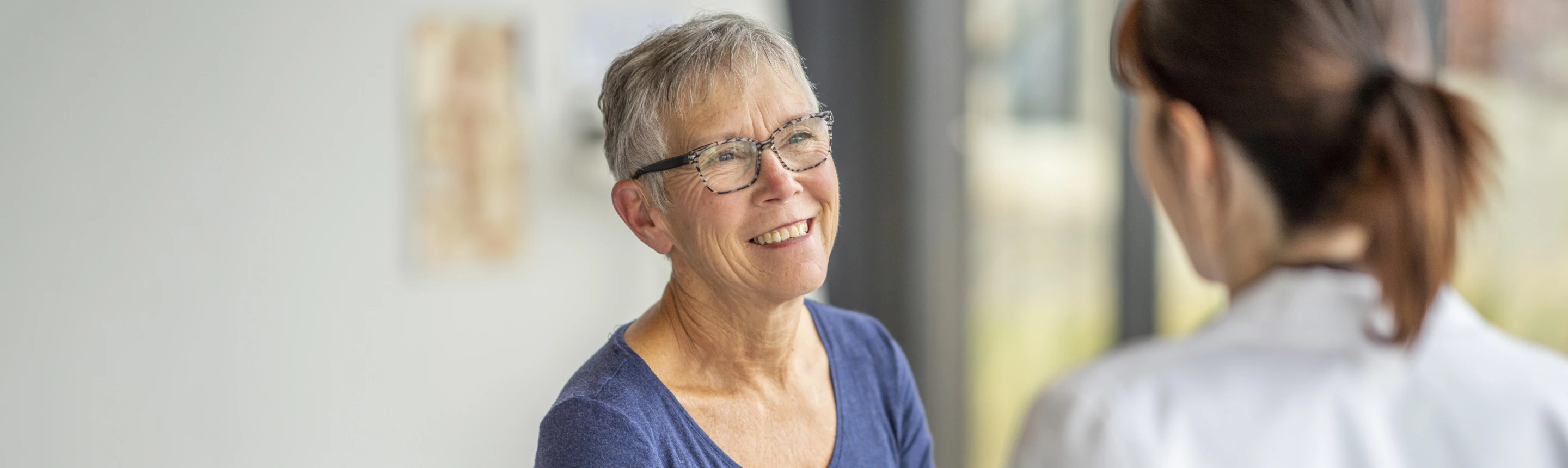 Image of patient smiling while talking to doctor