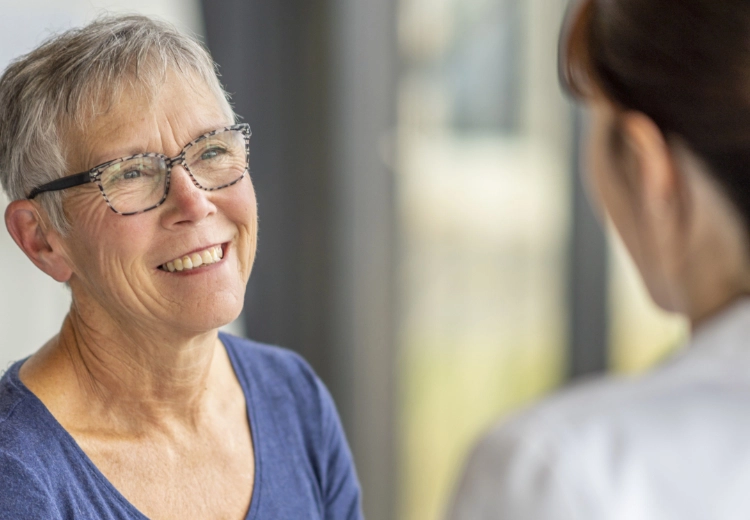 Image of patient smiling while talking to doctor